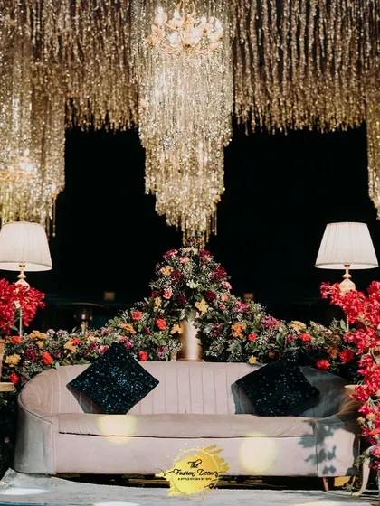 An unforgettable Sangeet night under a ceiling of shimmering tassels and crystal chandeliers. I designed this seating area to feel both grand and intimate, with rich florals and soft lighting creating a truly enchanting atmosphere for the couple. ❤️