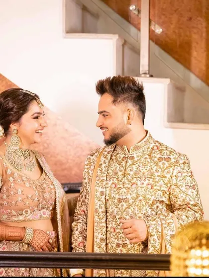 A happy moment between the couple. Her polki jewellery adds a touch of timeless grace to the modern outfit.