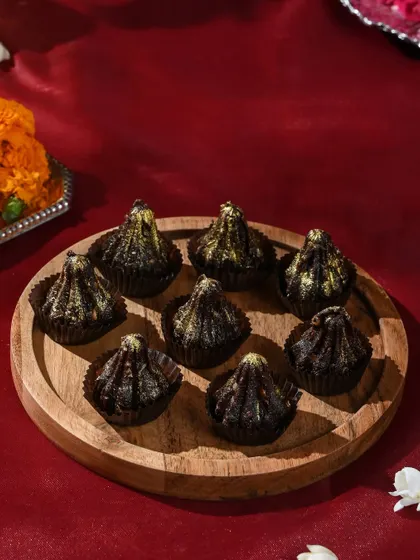 A perfect platter of my chocolate modaks, dusted with edible gold for a touch of festive glamour.