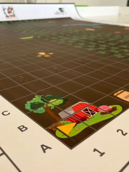 The corner of the IRO Explorers category mat for ages 5-7. The grid-based design helps our youngest learners program their first robots using simple directional commands.