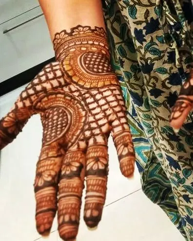 A full view of a guest's hand with a lovely check and floral design. It's a festive and beautiful pattern perfect for any celebration.