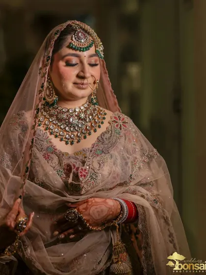 A close-up of the bride, capturing her serene expression and stunning jewelry.