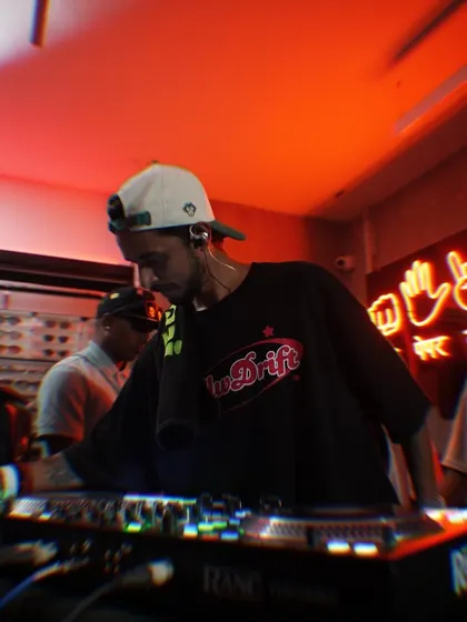 Another angle from the Slw Drift party, showing me focused on the mix. The red neon lights set the perfect mood for the night.