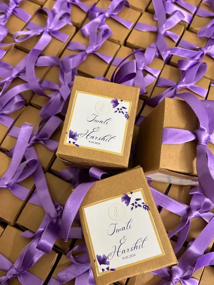 Here’s a look at a bulk order of wedding favors, all boxed up and ready to go. The purple satin ribbons and custom labels for Twati & Harshit created a beautiful, cohesive look.