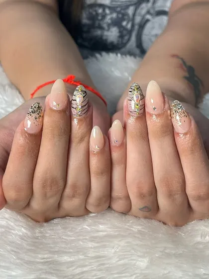 Another beautiful example of our bridal nail services. This client opted for elegant almond-shaped extensions with a subtle nude base, accented with glitter and a touch of animal print for a modern and chic look.