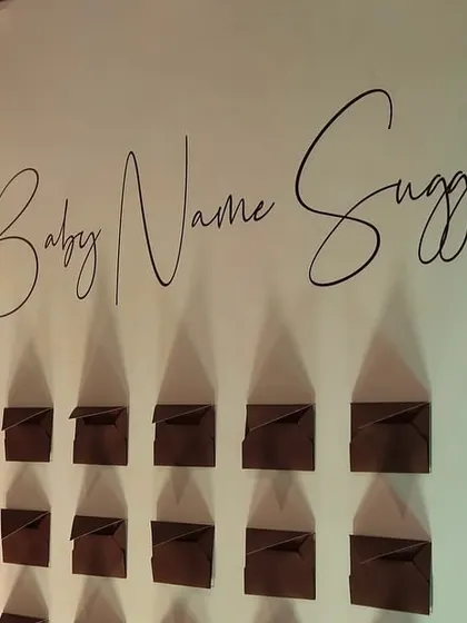An interactive 'Baby Name Suggestions' wall is a wonderful way to engage guests. We designed this elegant display with custom calligraphy to fit the baby shower's sophisticated theme.