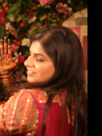 A candid shot of a guest admiring her fresh mehandi.