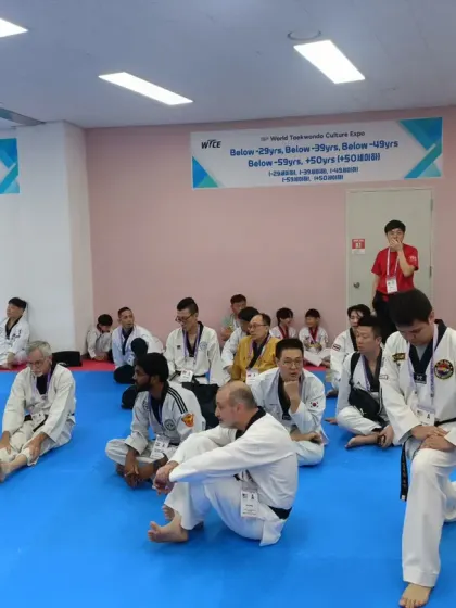 Athletes from different countries stretching and preparing together, a great display of sportsmanship.