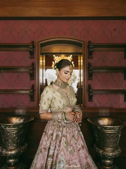The full view of Vasav's pastel dream. Her elegant hair bun and understated makeup allowed her intricate jewelry and stunning lehenga to shine.