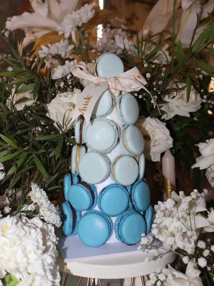 Elevate your dessert table with our stunning eggless macaron tower. This one features an ombré blue design and makes for a beautiful and delicious centerpiece at any event.