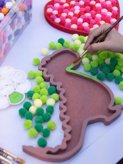 RAWR! This pom-pom dino is a super fun and tactile craft. You get to paint the base and then fill it with colorful, fluffy pom-poms.