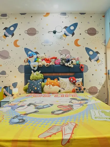 A fun and imaginative kid's bedroom with a space theme. The rocket and planet wallpaper sparks creativity, while the house-shaped study nook provides a perfect spot for homework and hobbies.