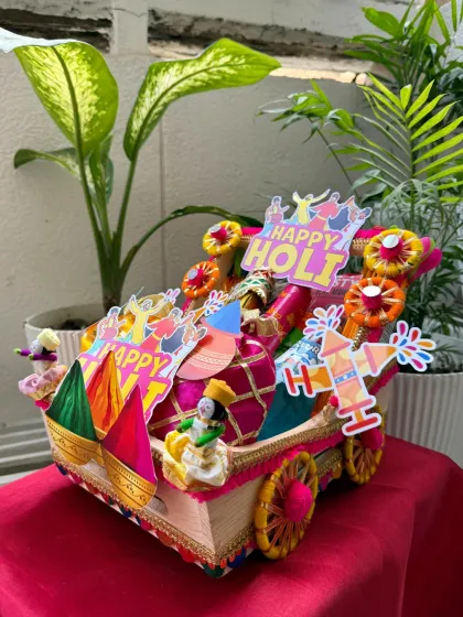 Our premium Holi hamper, priced at ₹1200, is designed to look like a festive cart. It's overflowing with snacks, drinks, and Holi essentials for the ultimate celebration.