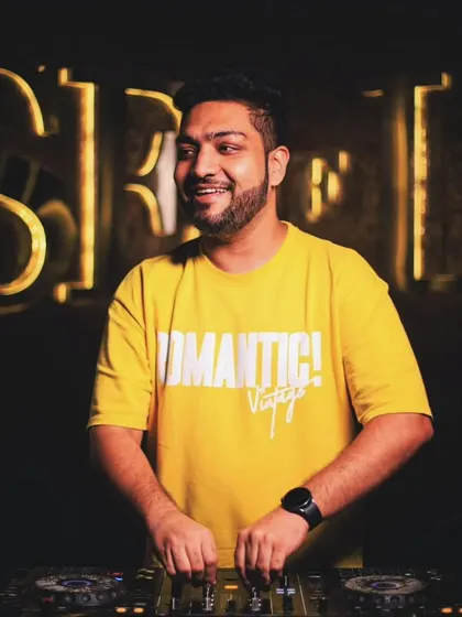 A happy moment behind the decks. The warm lighting and my smile capture the positive and fun atmosphere of my club nights.