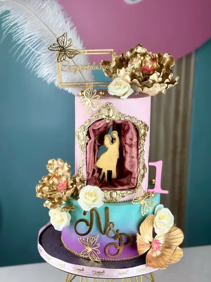 Love, laughter, and a lifetime together. This ombre anniversary cake is celebrated in gold and vibrant colors, featuring a silhouette of a dancing couple.