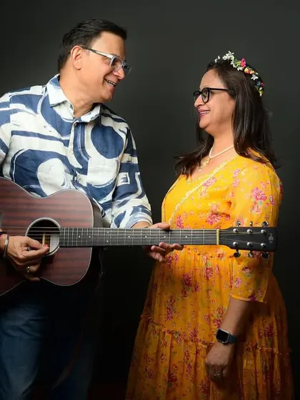 A musical moment from a 25th-anniversary shoot. The husband plays the guitar for his wife, creating a personal and heartfelt image.