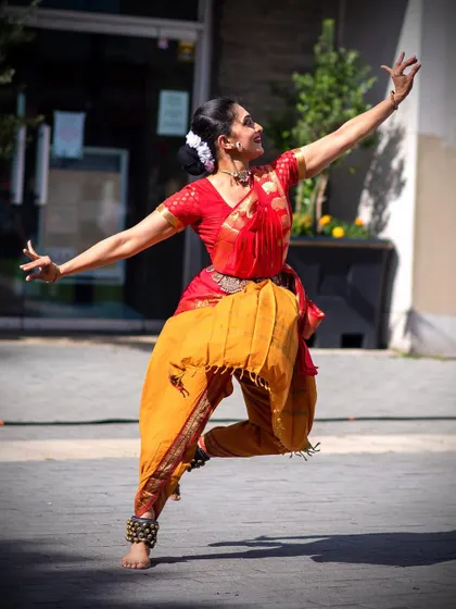 A dynamic leap during the outdoor performance of "Ananda - Abandon," bringing the energy of Marathi poetry to the streets of London.