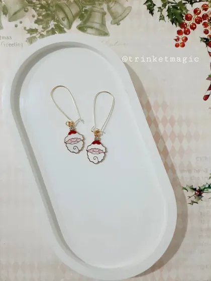 Add a sprinkle of Christmas magic to your look with these Santa moon hoop earrings. They are lightweight and perfect for holiday parties.