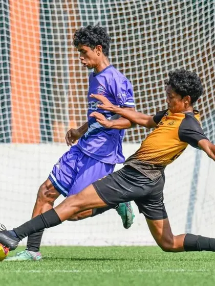 A player executes a perfect slide tackle to win the ball in the DPDL finals.