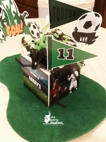 Every detail counts. This custom centerpiece for the football party tables included themed pennants, the number 11, and images of the birthday boy, ensuring the theme was carried through to every corner of the event.