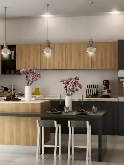 This kitchen features a two-tiered island with a prep area and a dining table. The mix of dark grey and light wood cabinets creates a balanced and modern look.
