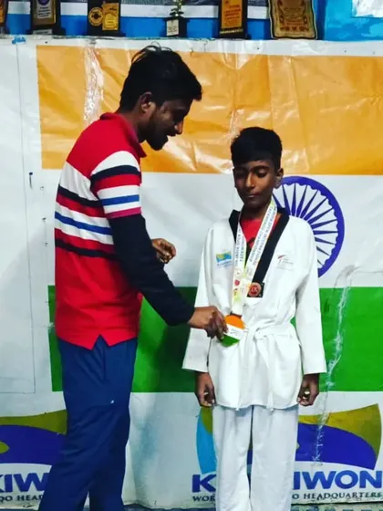 Presenting the medal to my student. This is the reward for his dedication.