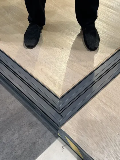 This image shows the seamless corner joint of a Tostem sliding door track. This level of precision ensures smooth operation and prevents dirt from getting trapped. It's a detail that highlights the superior quality of system aluminium compared to locally fabricated options, providing a clean and functional solution for your home.