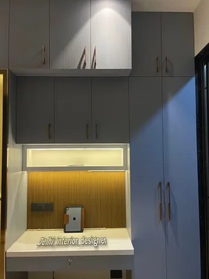 A closer look at the wardrobe and study table combination. The rose gold handles add a touch of elegance to the matte grey cabinets.