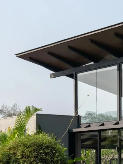 A detail of an Alibaug home, where a large roof overhang provides shade and protection from the monsoon rains. The design is a direct response to the tropical climate and the need for durable, breathable buildings.