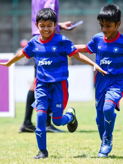 A young player celebrates after scoring a goal in the KSFA Youth Premier League. We encourage our players to enjoy their successes.