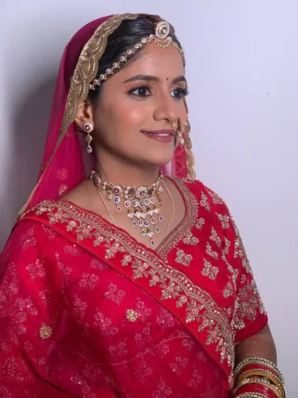 A three quarter profile showing the complete look with the dupatta set. The makeup is perfectly balanced to look stunning from every angle.