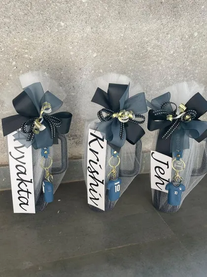 Personalized mugs wrapped and ready to be gifted as return favors. Each mug is customized with a name and a themed keychain, making it a fun and practical gift for kids' birthday parties.