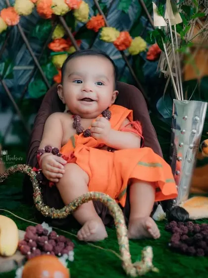 Surrounded by fruits and flowers in his little forest setup, this baby Ram is the picture of divine happiness.