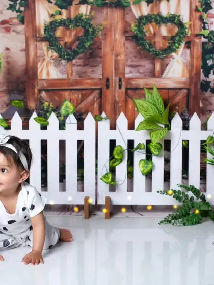 A sweet crawling pose from a one-year-old in our lush green and white panda garden theme.