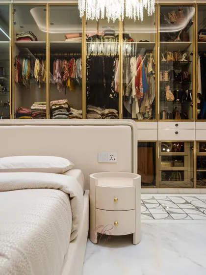 This angle shows the seamless connection between the bedroom and the open walk-in closet. The custom bedside table and the elegant wardrobe design create a cohesive and luxurious master suite.