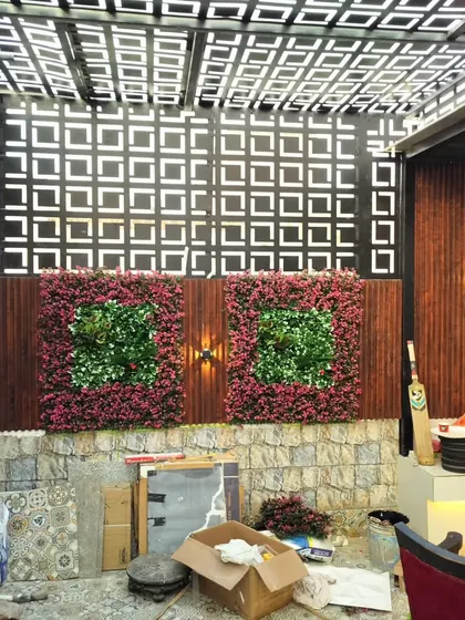 The Najafgarh project during construction, showing the installation of the laser-cut screens and artificial plant panels.