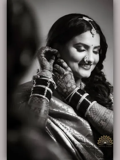 A beautiful black and white portrait of a bride. The monochrome effect highlights the intricate patterns of the mehndi, showing its beauty beyond color.