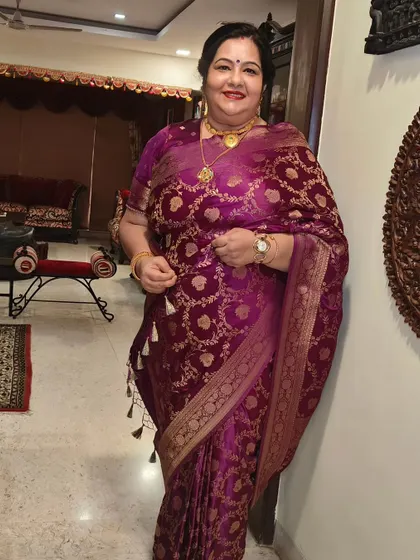 A full-length shot showing her complete look. The saree, hair, and makeup all come together to create a picture of grace and sophistication.