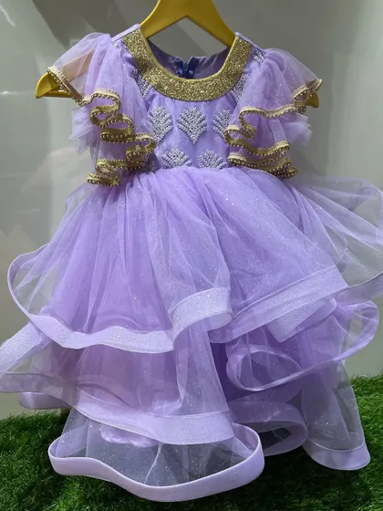 A lavender frill frock with beautiful golden detailing on the neckline and sleeves.