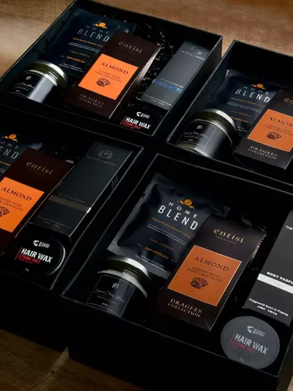 A sophisticated hamper perfect for farewells or celebrating a male colleague. This gift set includes premium men's grooming products like hair wax and body parfum, paired with gourmet coffee and chocolates.