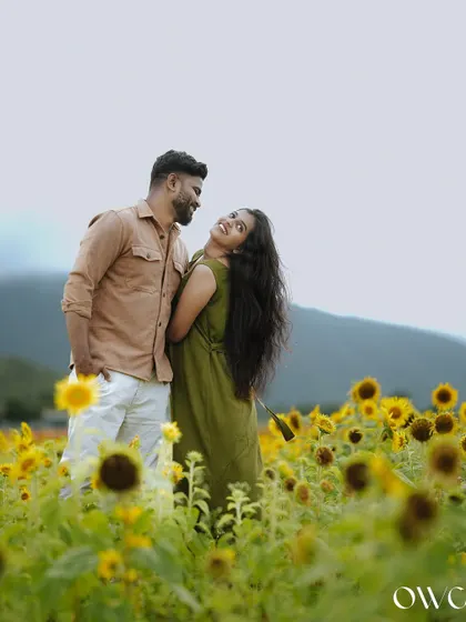 A happy couple surrounded by a field of sunflowers, a perfect setting for a vibrant and cheerful pre-wedding photoshoot.