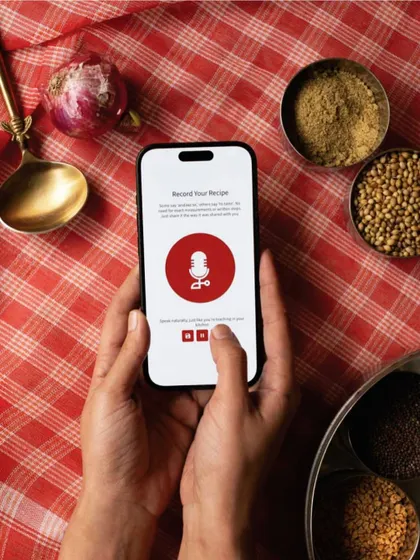For generations, recipes have been shared through voice. Our app was created to honor that tradition, capturing the 'chutki bhar' (pinch of) salt and the stories that come with it. Just press the red button to start recording.