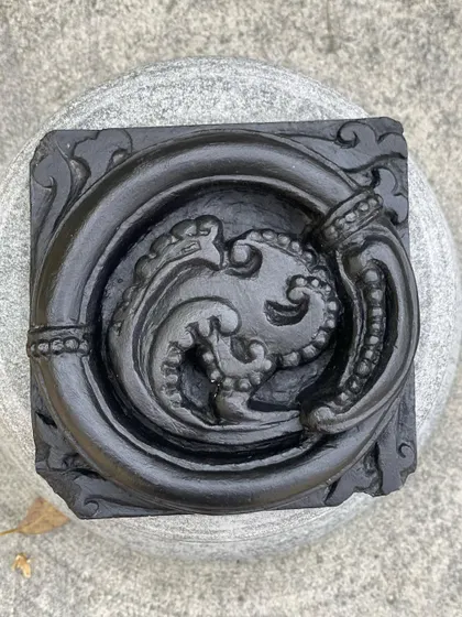 A close-up of our circular vine plaque, a unique decor item inspired by the beautiful, flowing patterns found in temple architecture.