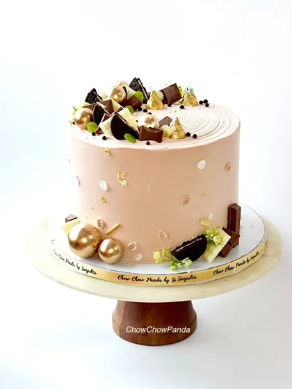 A side view of the elegant chocolate cake, showing the texture and decorations.
