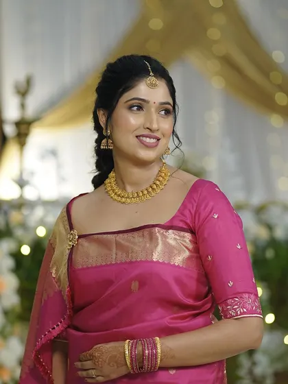 Another angle of the bride's Oorkuduva look, showing her elegant hairstyle and the fresh, natural finish of her makeup.
