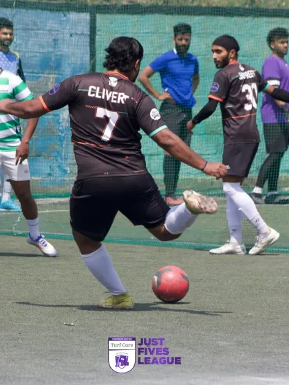 A player takes a powerful kick, with teammates looking on. Every moment is an opportunity to make a difference for the team.