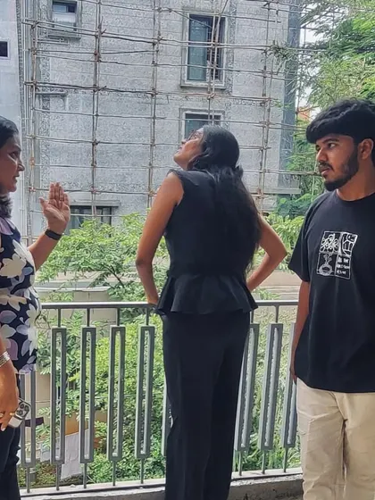 A candid moment of discussion and mentorship on a construction site. We believe in nurturing the next generation of architects through hands-on experience and open dialogue.