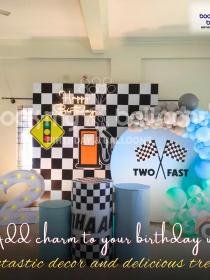 This "Two Fast" race car theme shows how we add charm to your birthday with fantastic decor. The checkered flag backdrop and traffic light prop create a fun and immersive experience.