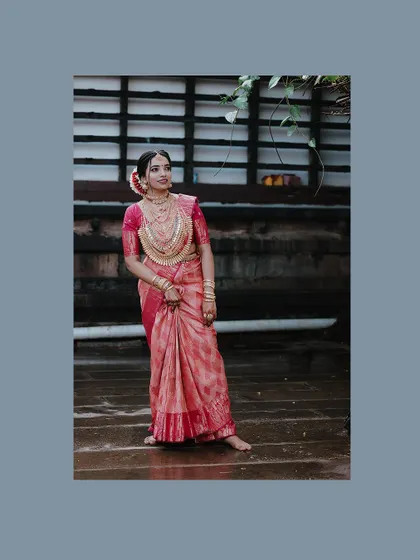 An elegant full-length portrait of the bride, framed in a cool blue border.