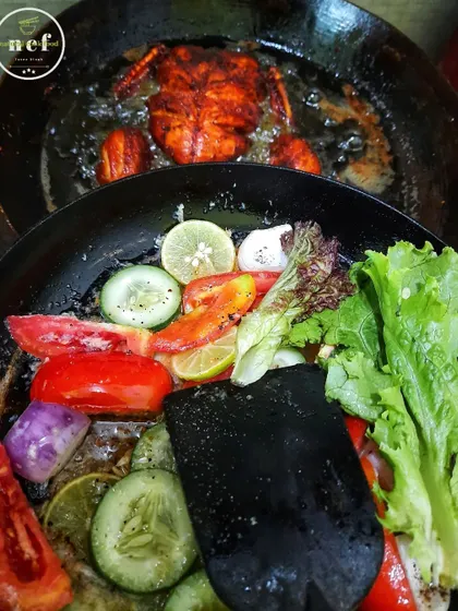 Frying a whole chicken while simultaneously preparing a fresh salad. This shows how I manage different components of a meal.
